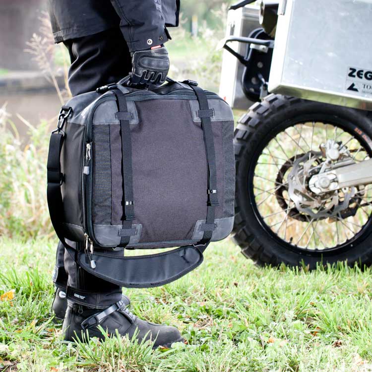 Kriega KS40 Travel Bag Black - 30 To 40 Liters - carried beside an adventure motorcycle