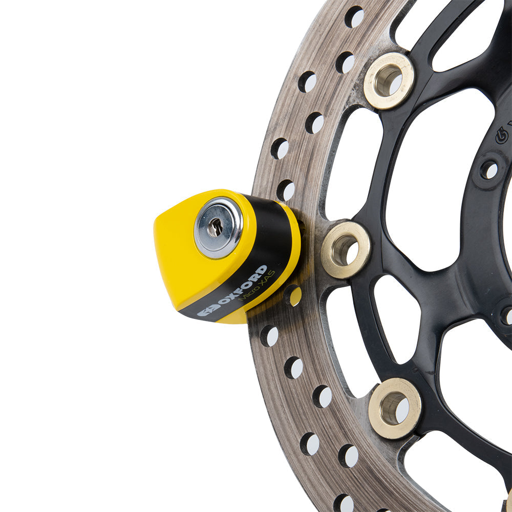 Oxford Micro XA5 Alarm Disc Lock Yellow / Black, fitted to a motorcycle brake disc