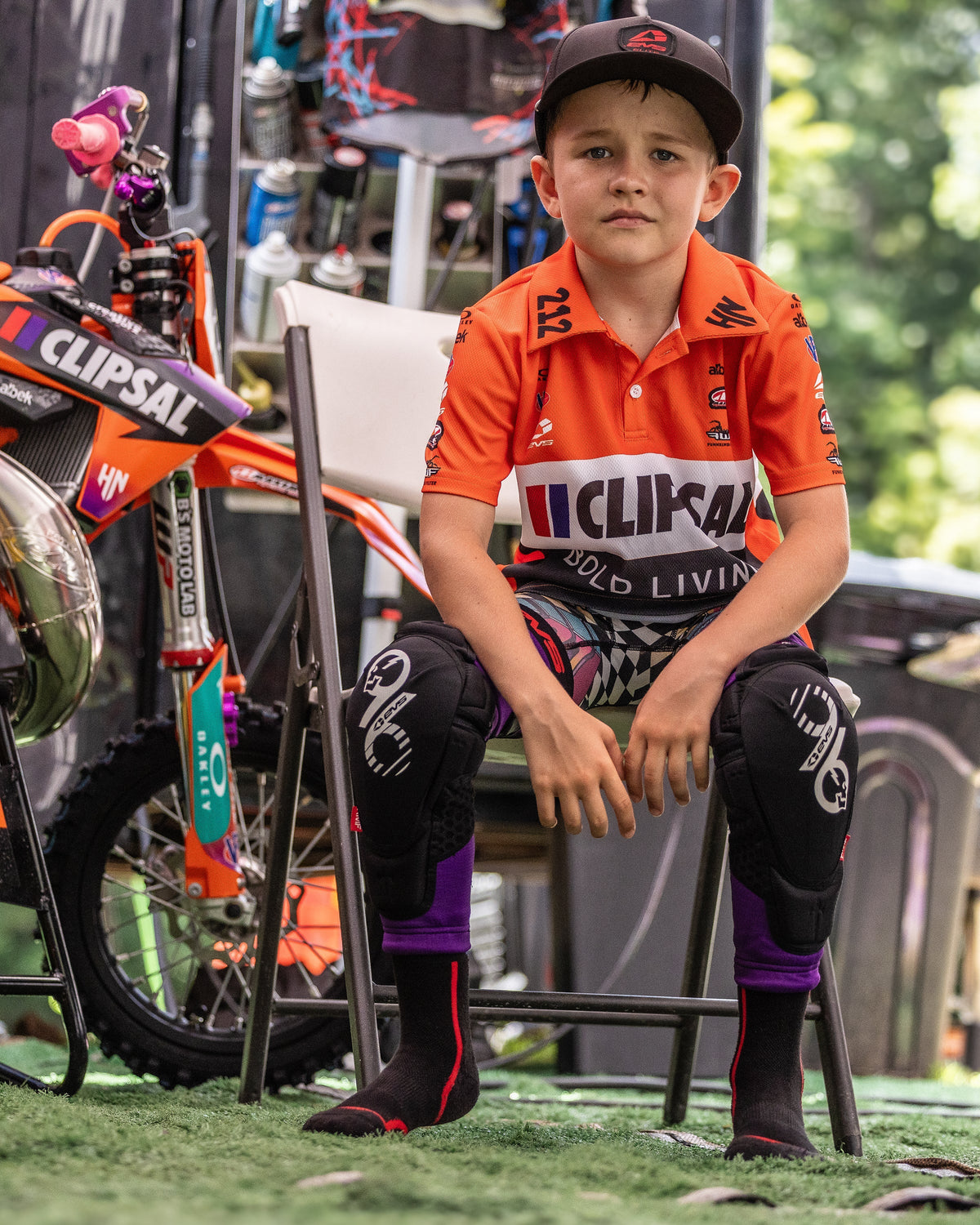 EVS Slayco Youth Knee Guards Purple / Black worn by a youth rider