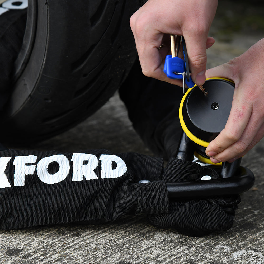 Oxford Beast Lock Chain Black - 22mm x 1.5m, fitted through a motorcycle wheel